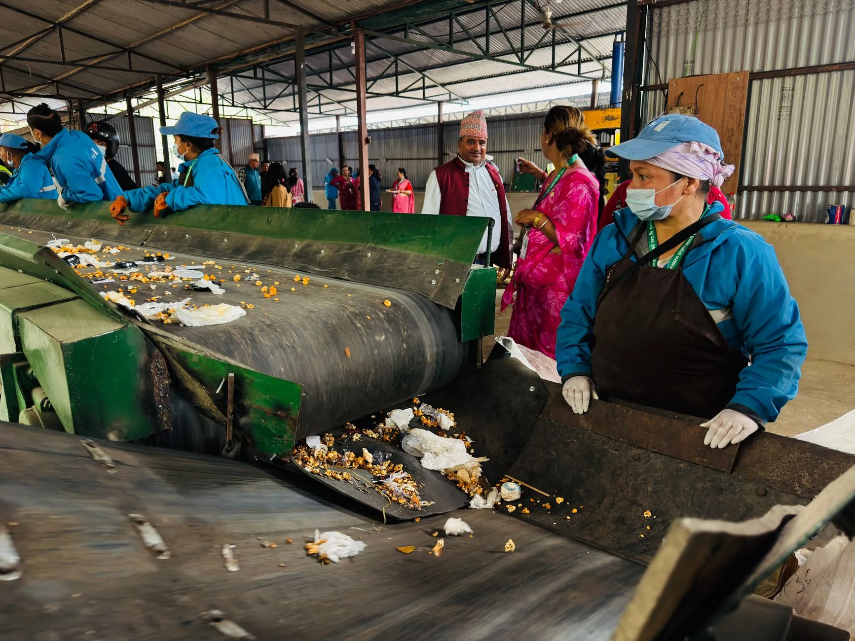 Workers sorting waste in a recycling facility in Butwal, Nepal, showcasing environmental sustainability efforts.